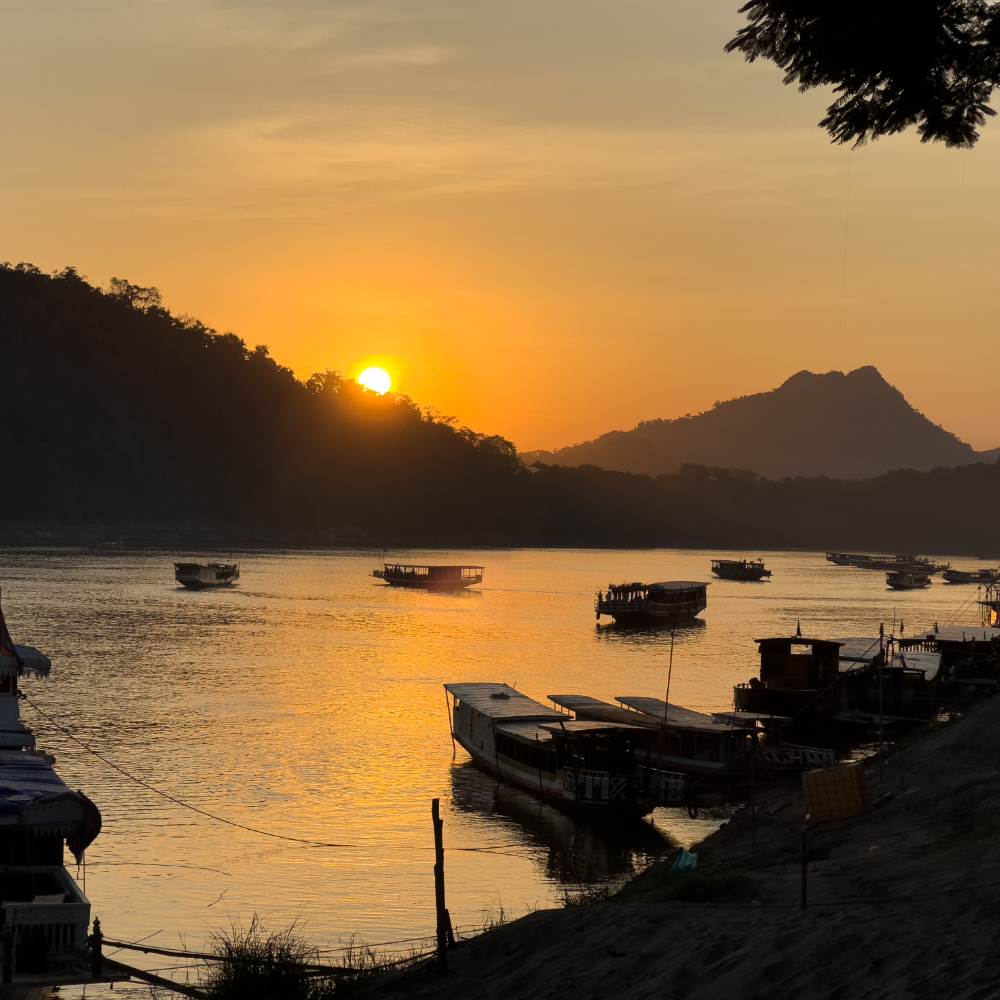 Mekong River Laos at Sunset with River boats Luang Prabang