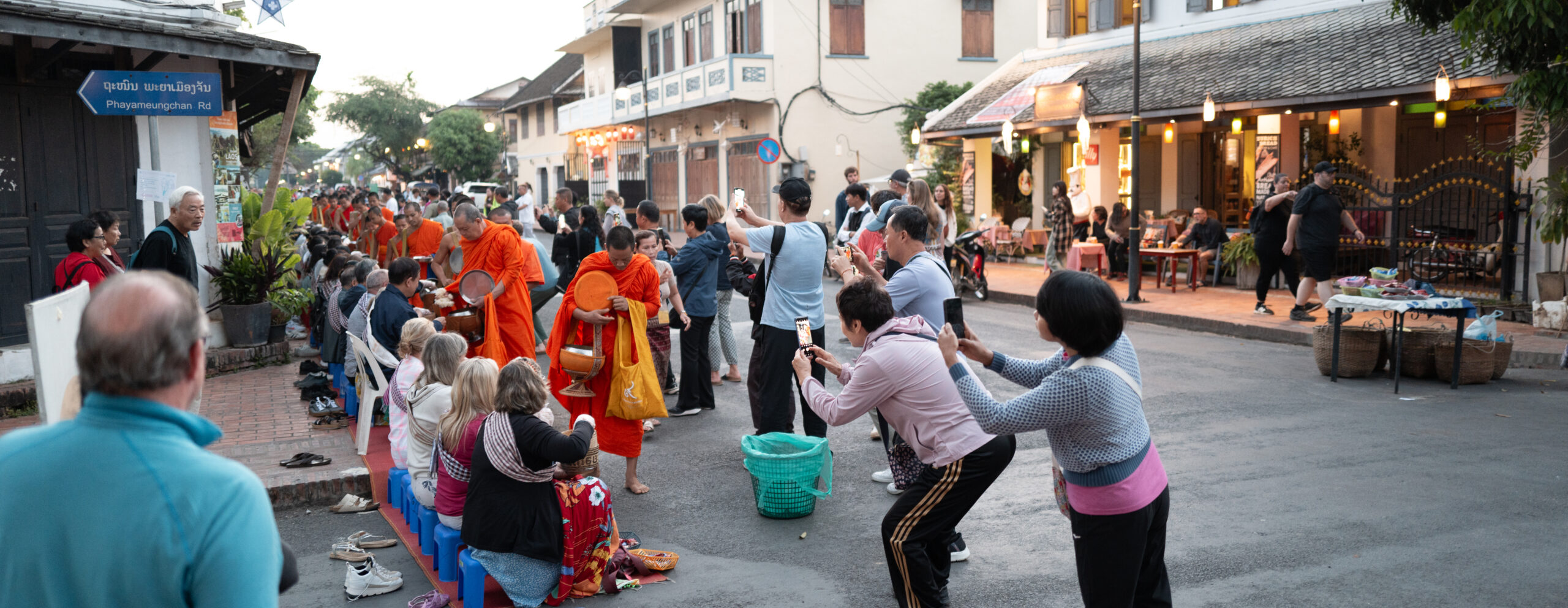 a group of people taking pictures of a monk