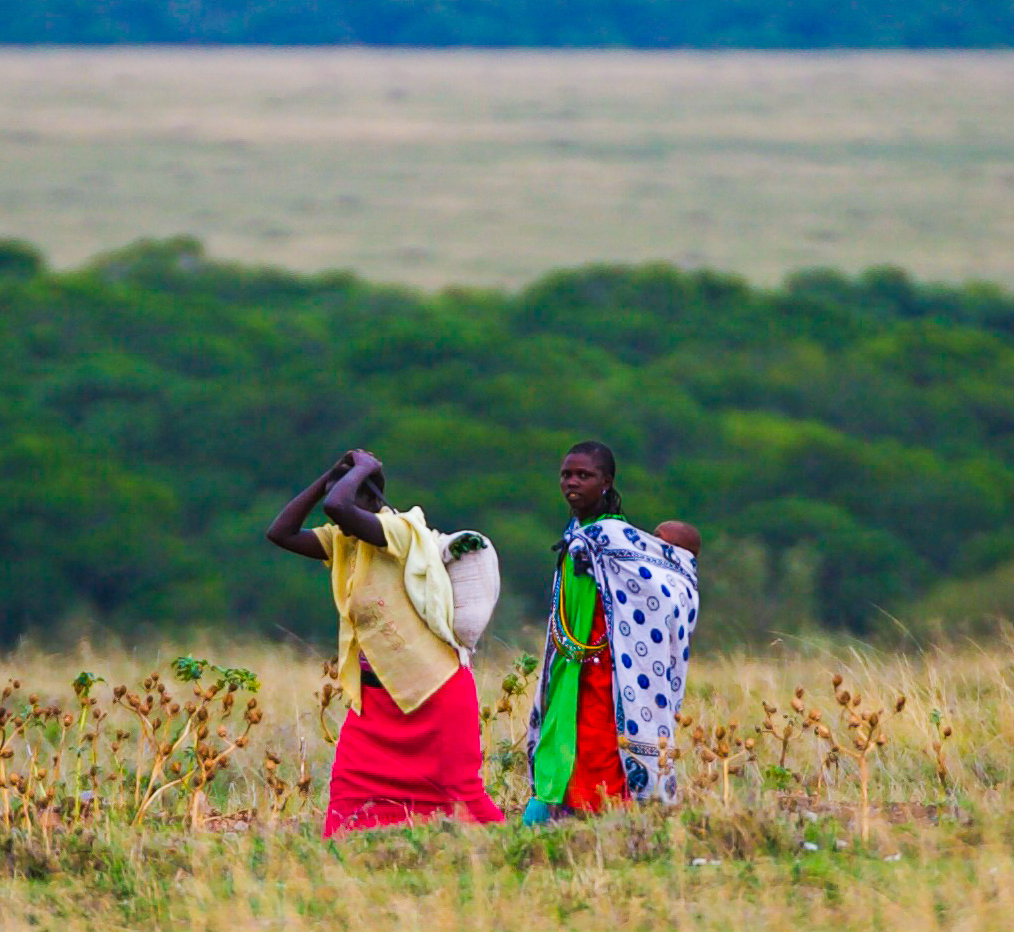 Tribal ladies walking in savannah plain of africa